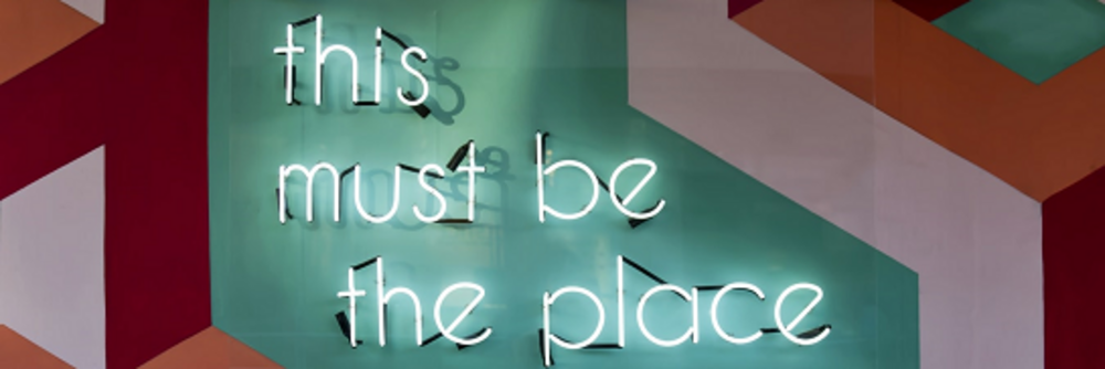 Illuminated letters on the wall stating this must be the place