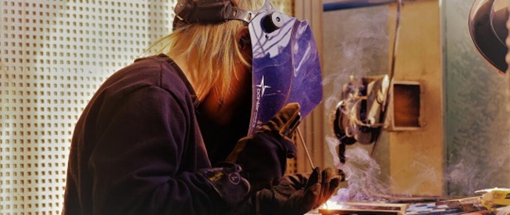 Young man welding.