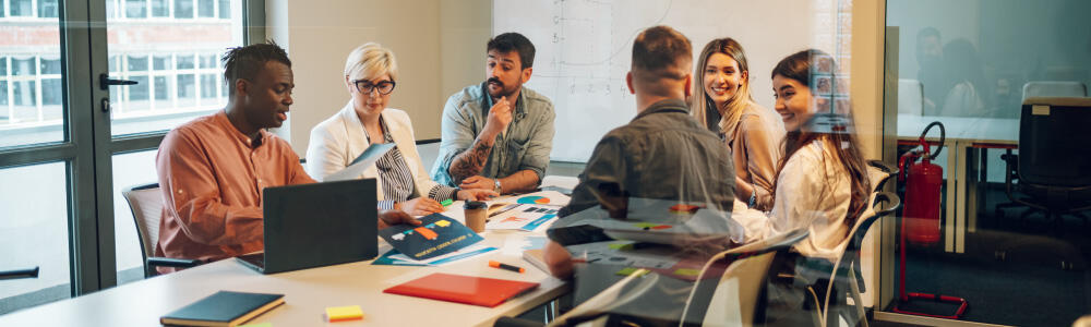 Workers around a table in an office