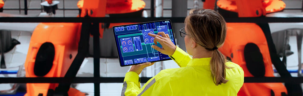 Woman inspecting a car assembly line