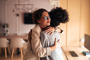 Women colleagues hugging