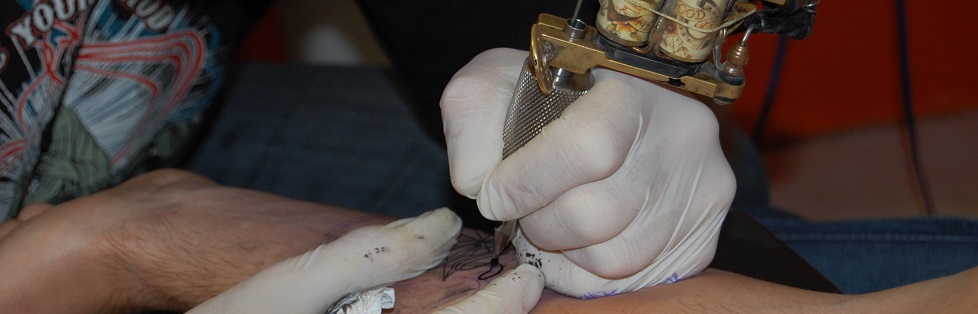 Close-up image of a hand making a tatoo